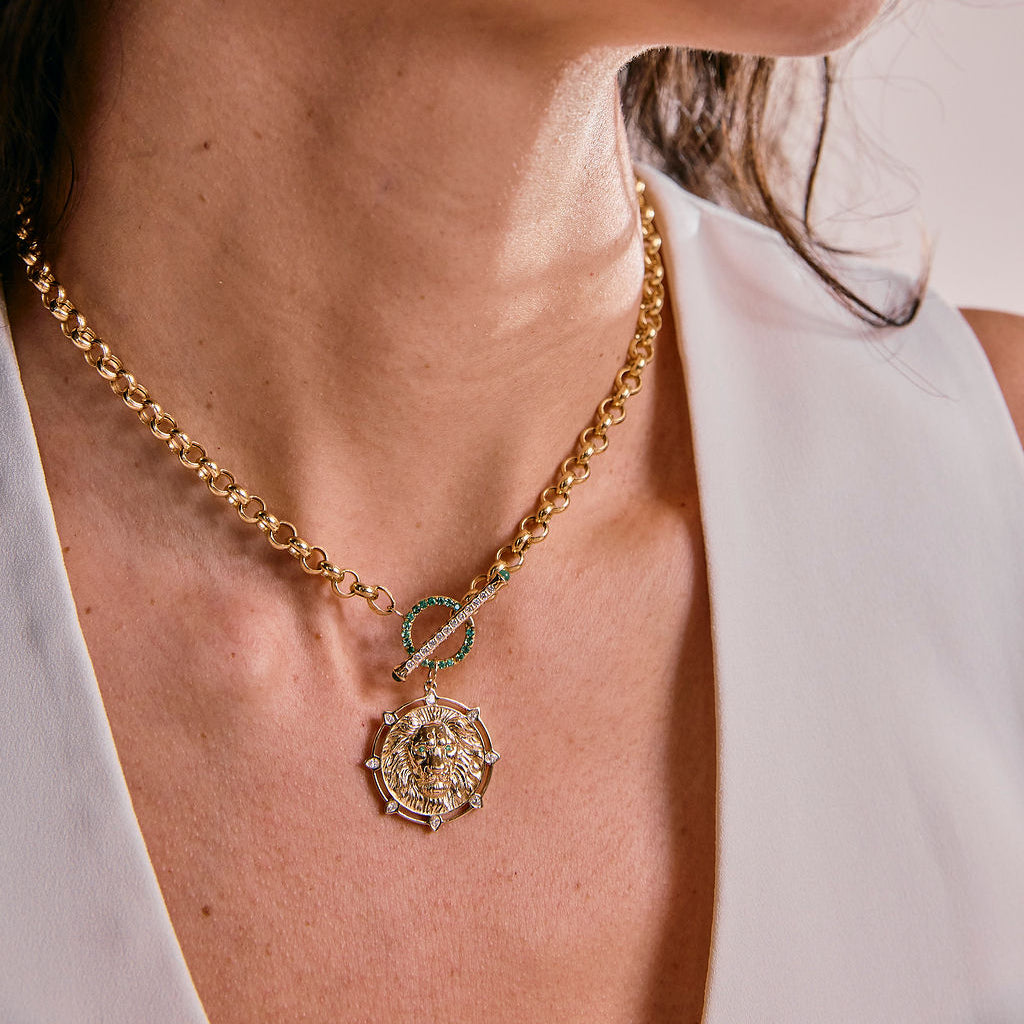 Woman wearing 14k gold lion charm on a chain