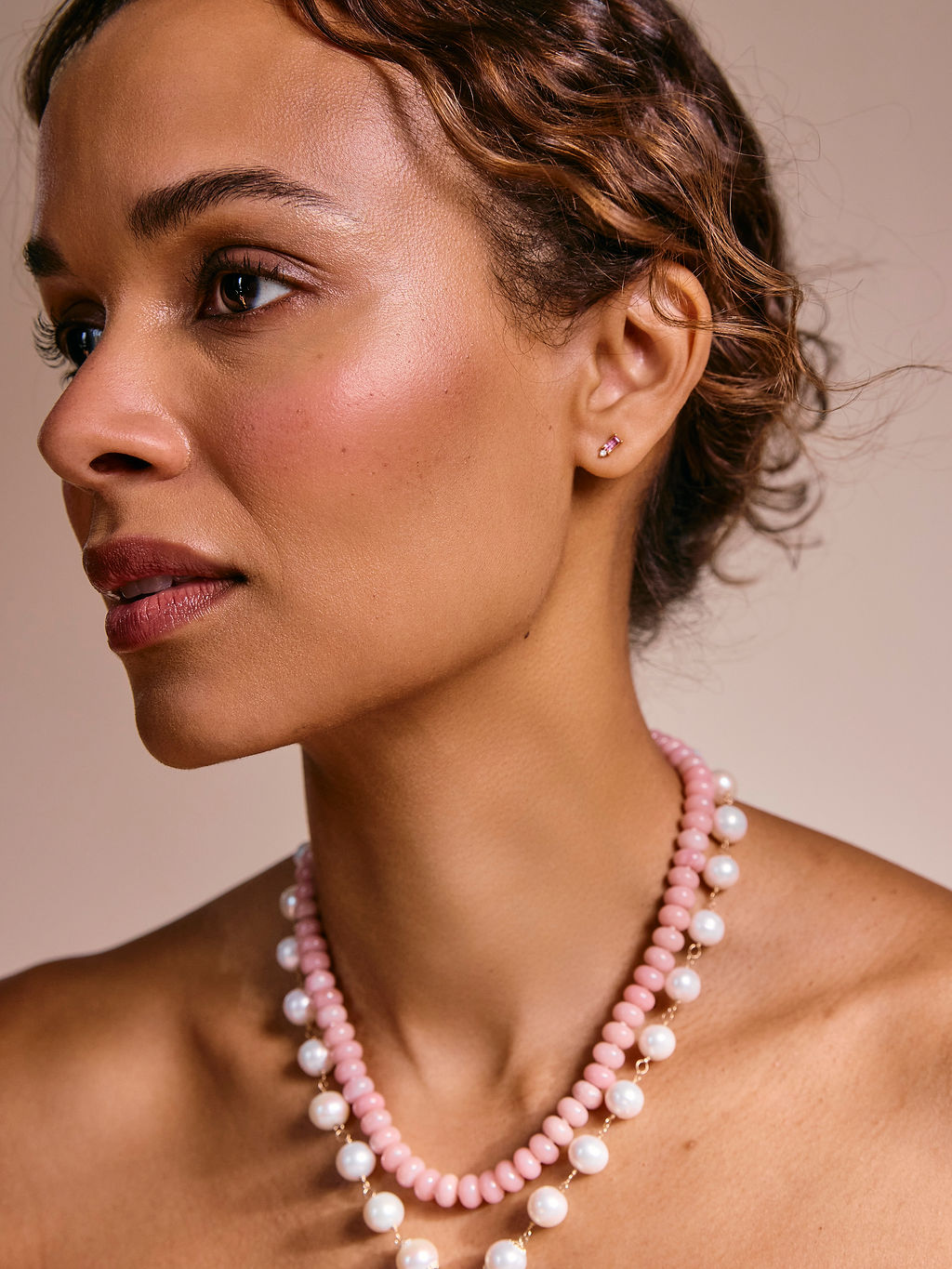 Pink Baguette Stud worn by a model with layered pink opal and pearl necklaces