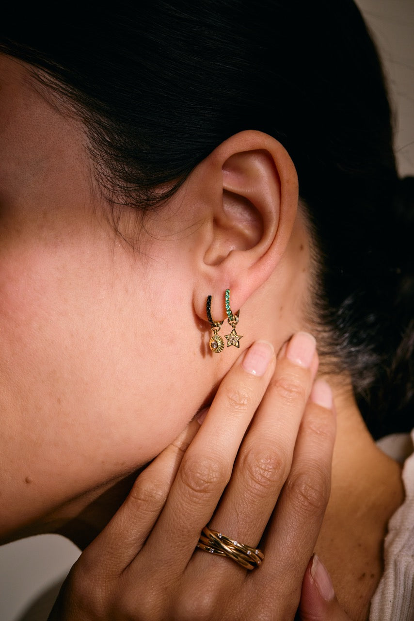 Side view of 14k gold Clarity earring charm showing sunburst-inspired design