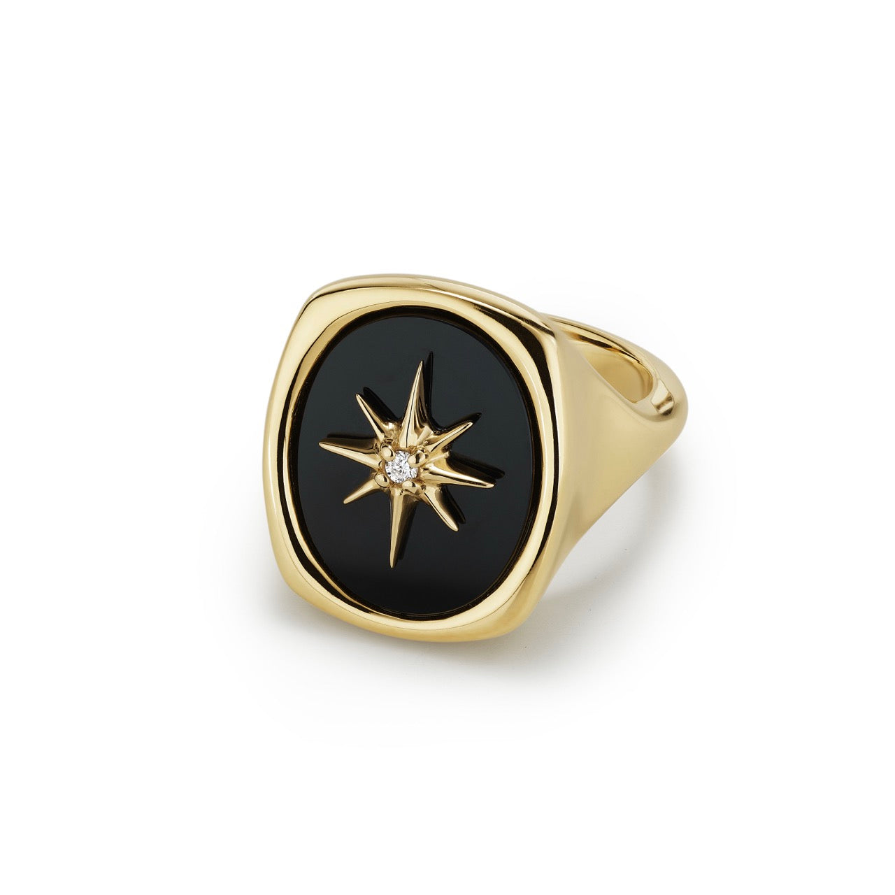 A 14k gold and black onyx signet ring, set with a gold starburst accented by a single diamond
