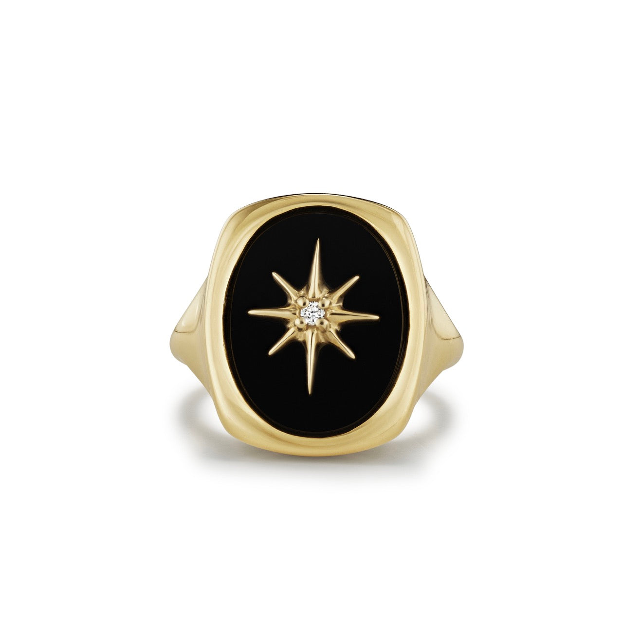A 14k gold and black onyx signet ring, set with a gold starburst accented by a single diamond