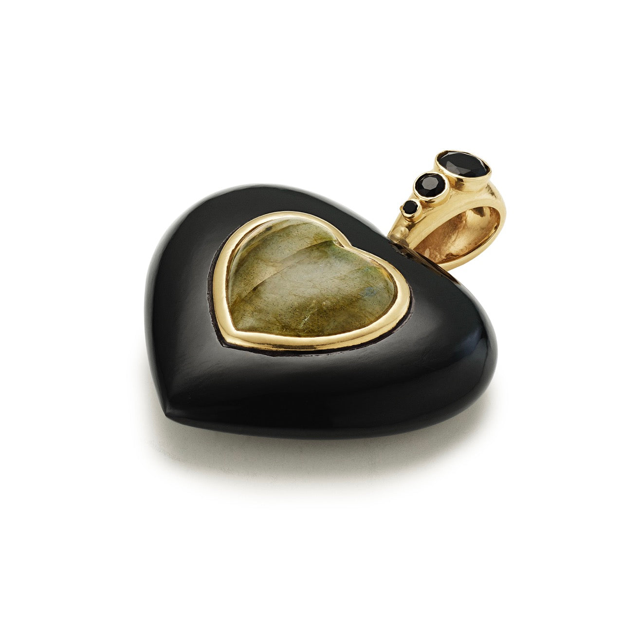 Black heart-shaped pendant with gold and green stone on a white background