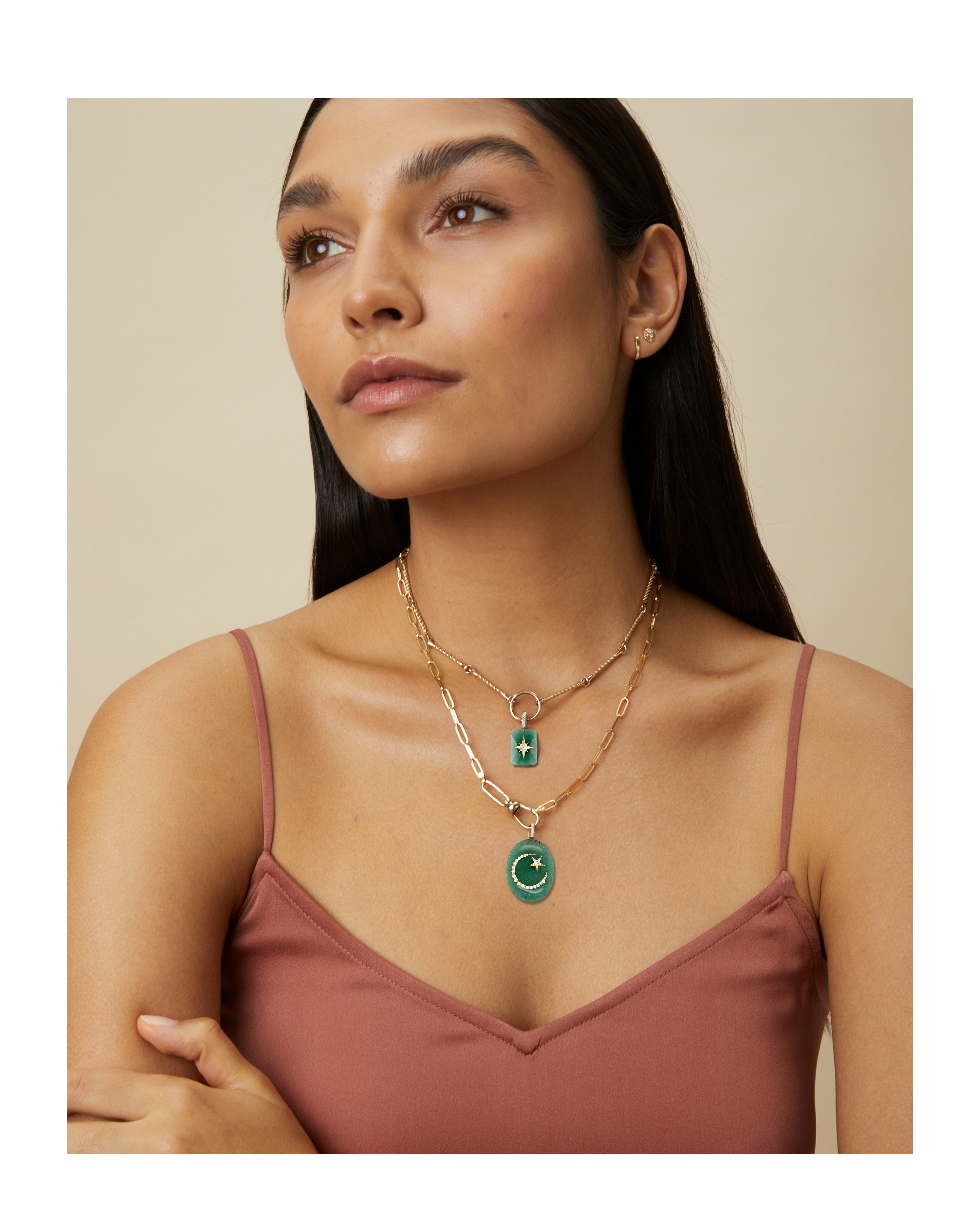 Model wearing layered necklaces including Green Aventurine cabochon starburst pendant