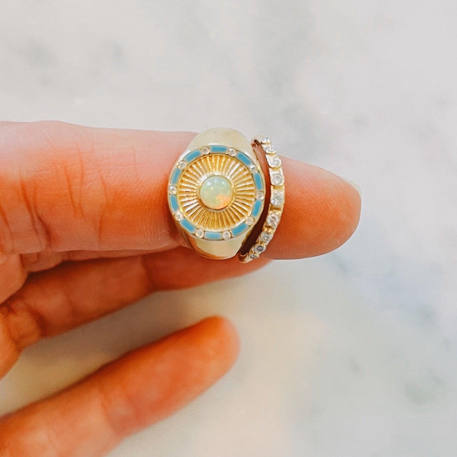 Close up of Opal and diamond sunburst Clarity Signet Ring promoting insight and optimism