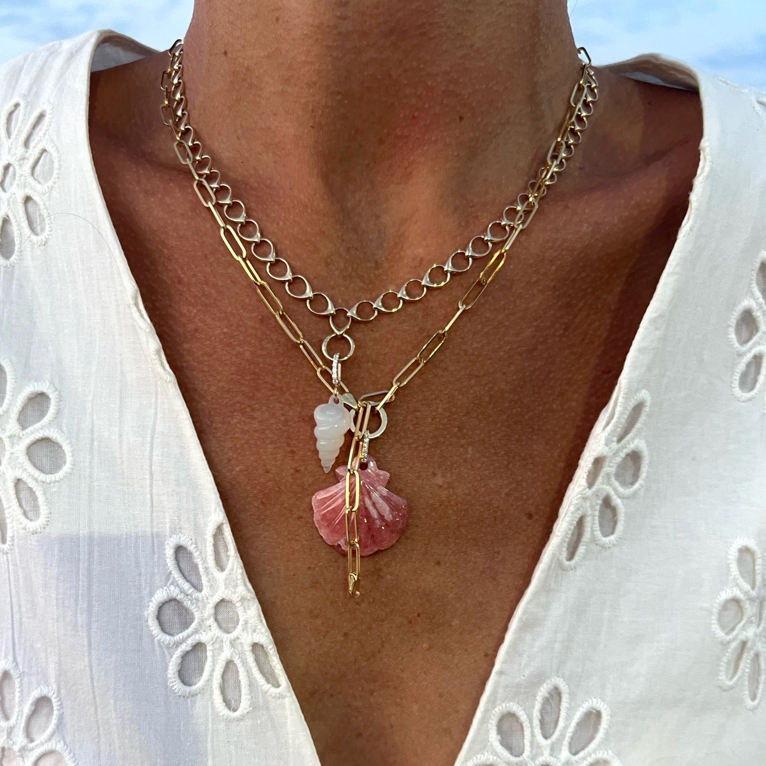Model wearing paperclip chain and seashell pendant