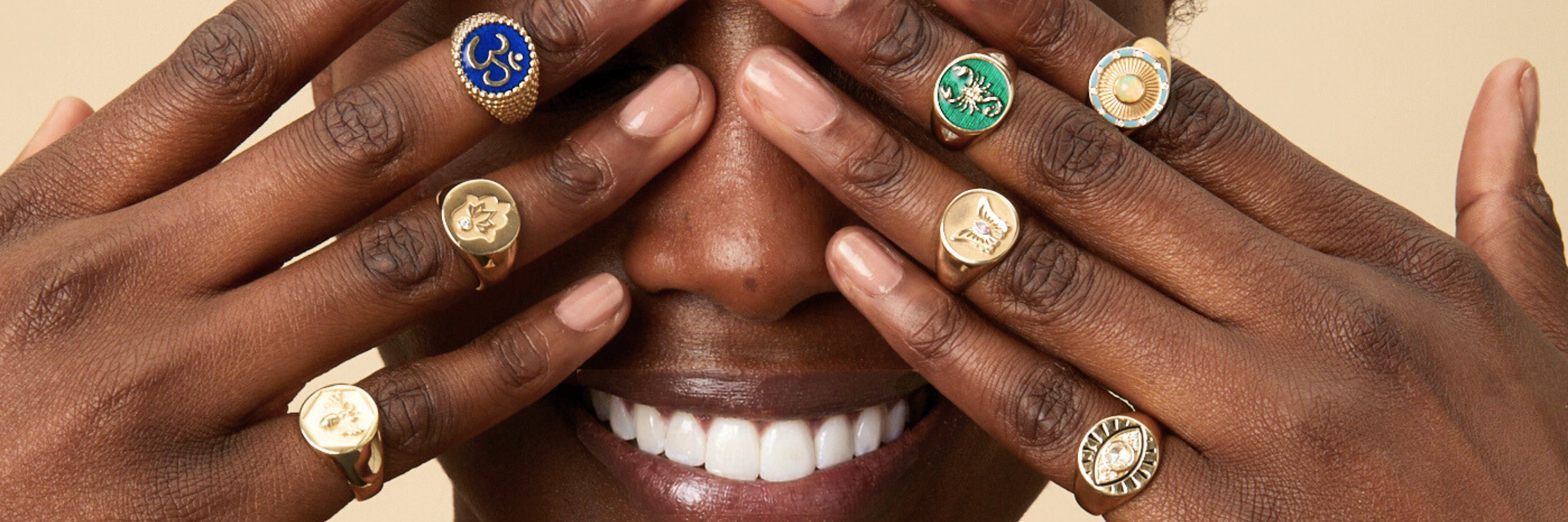 Symbols of Abundance, expressed through meaningful symbols worn on two hands in front of a face