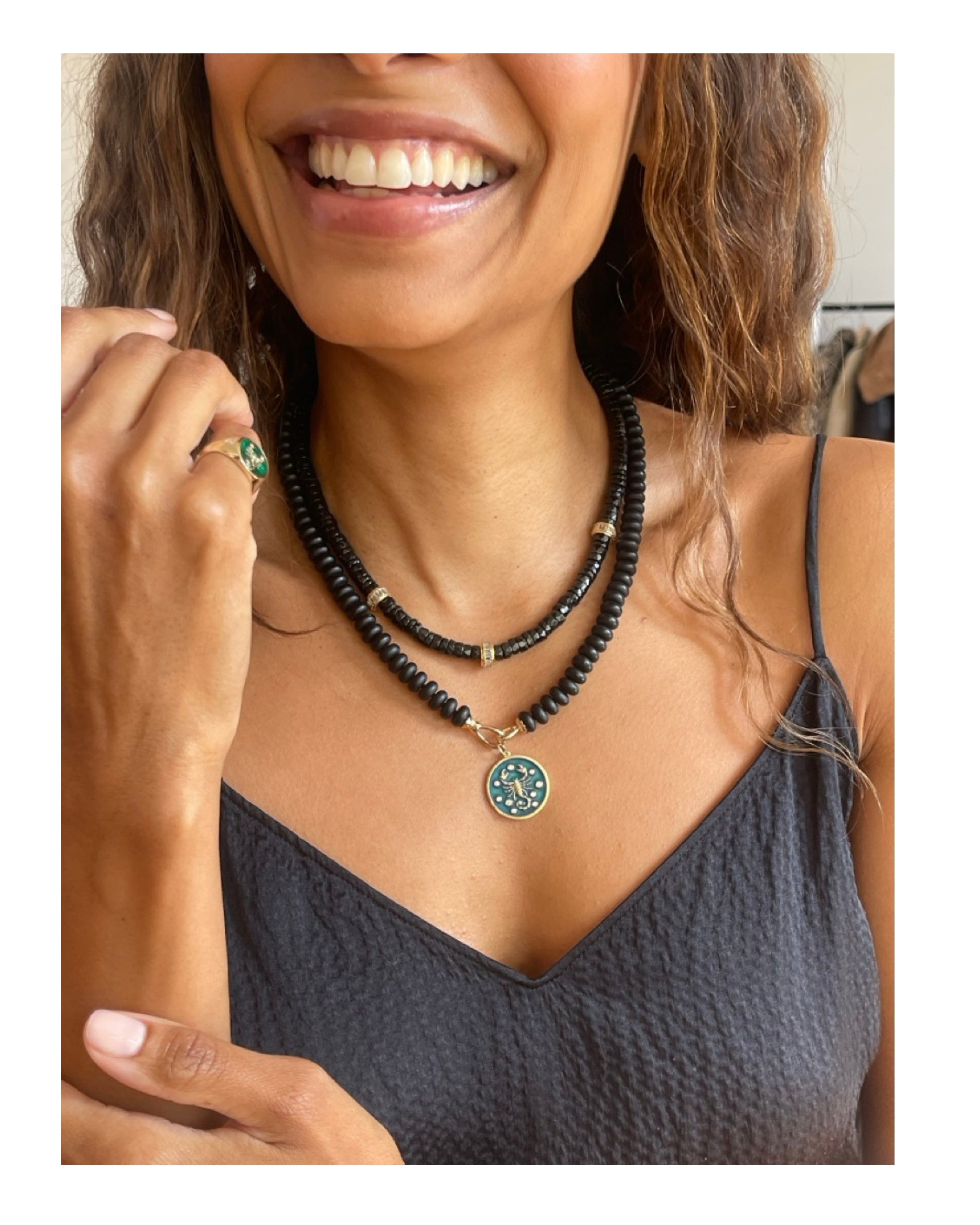 black onyx jewelry collection in solid gold including rings necklaces and charms