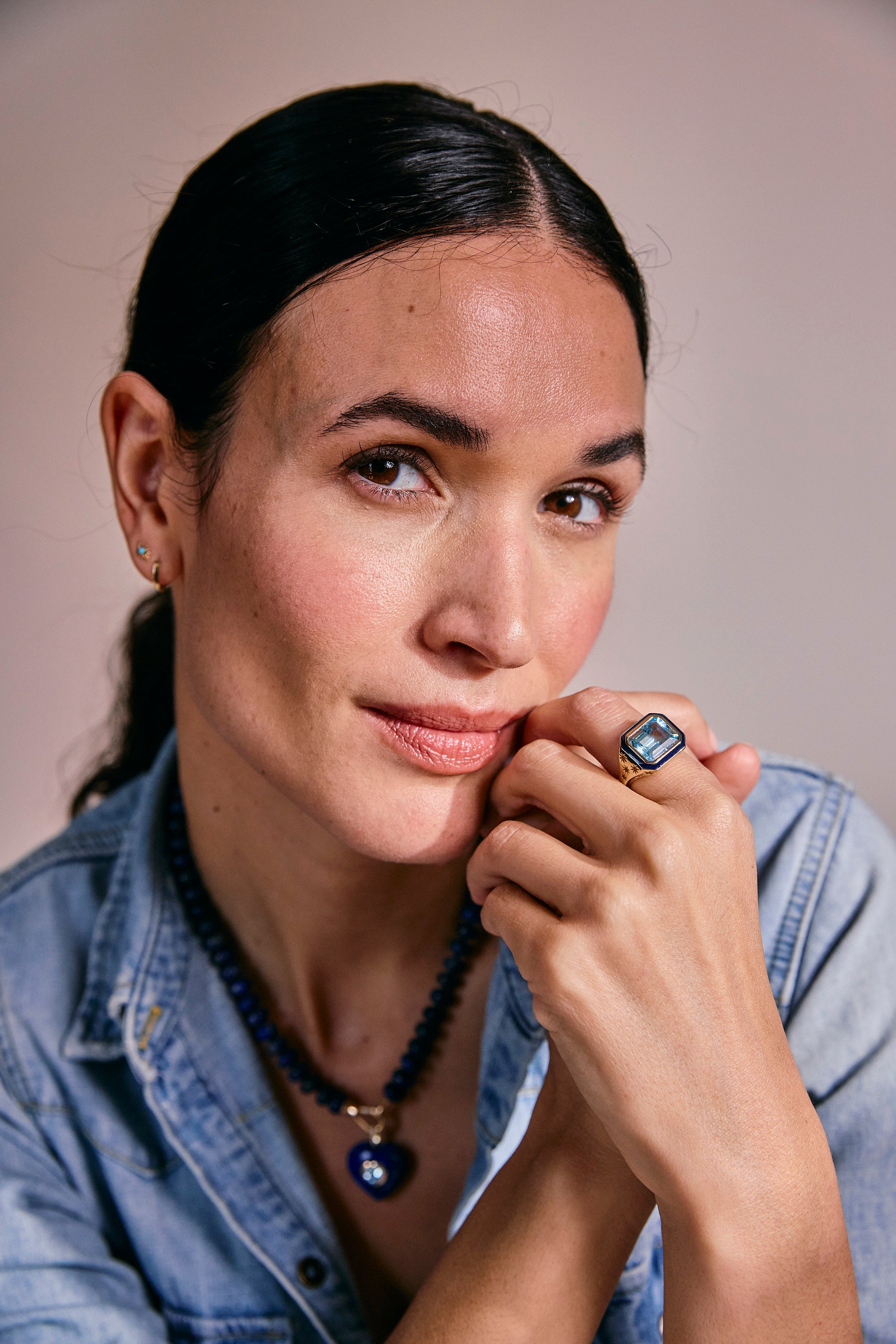 Model wearing Starlit Ring layered with necklaces from the Celestial Collection