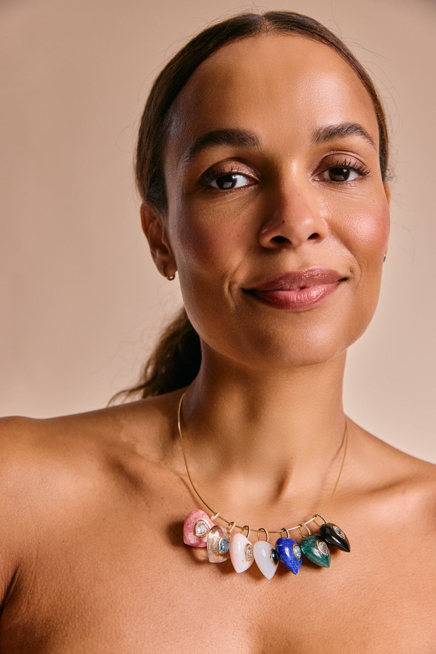 Woman wearing a colorful heart gemstone necklace