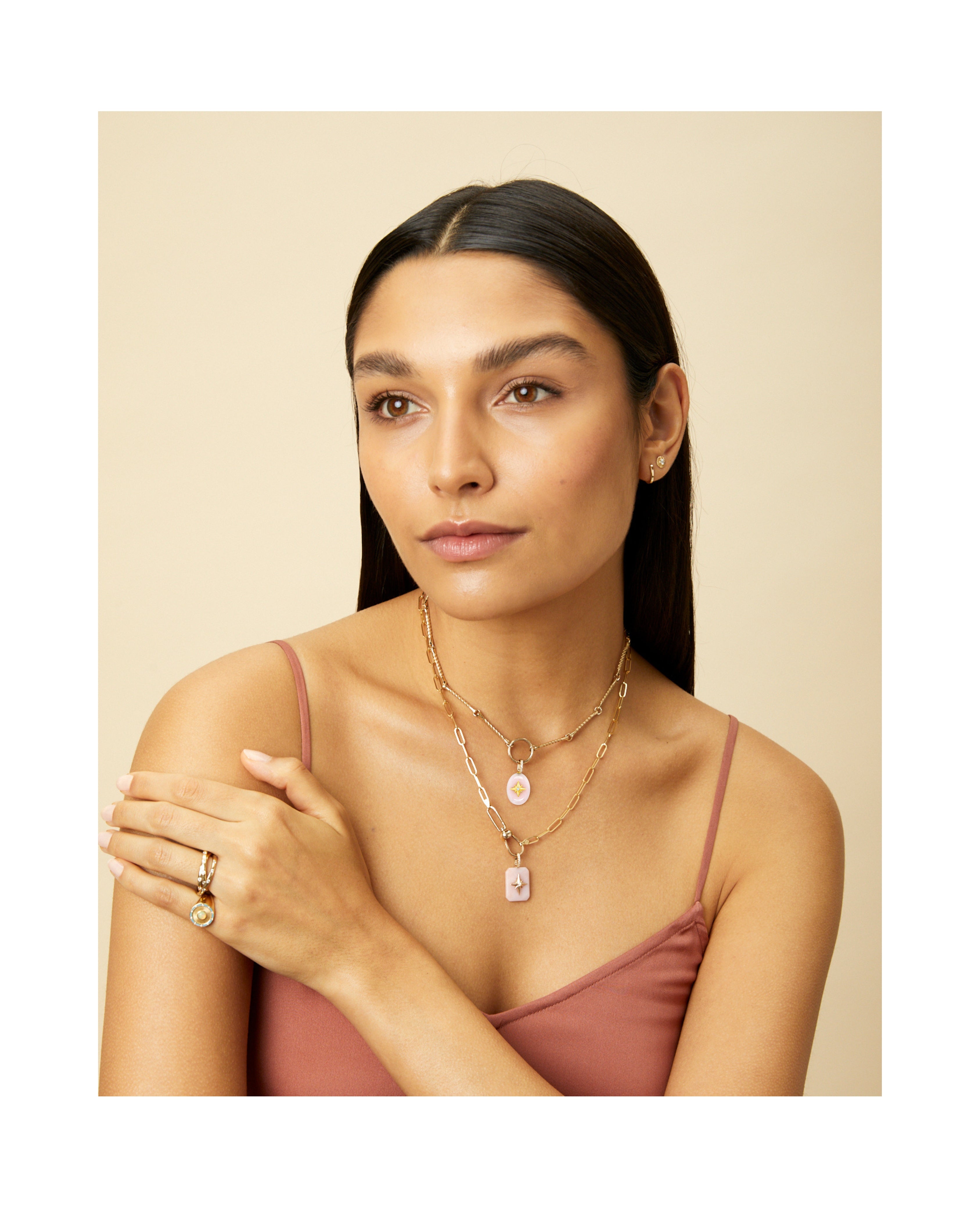 Pink Opal oval cabochon pendant with gold starburst and diamond bail on white background