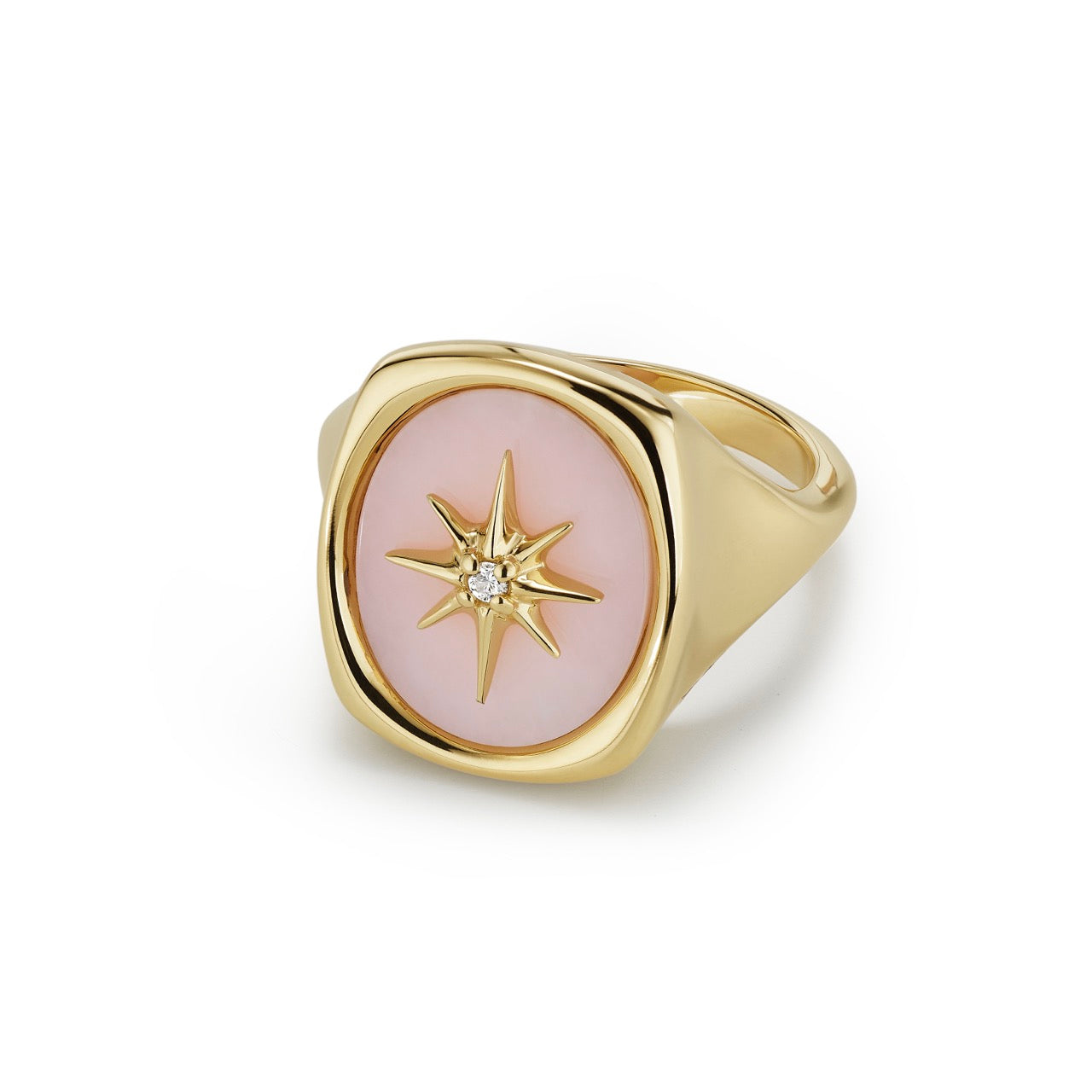 A polished oval of Pink Opal is set with a gold starburst accented by a single diamond
