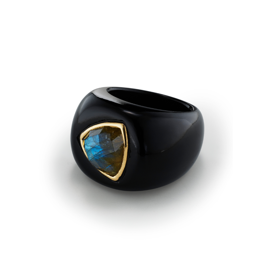 Black ring with a gold and blue gemstone on a white background