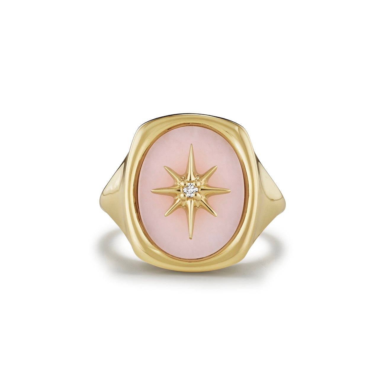 A polished oval of Pink Opal is set with a gold starburst accented by a single diamond
