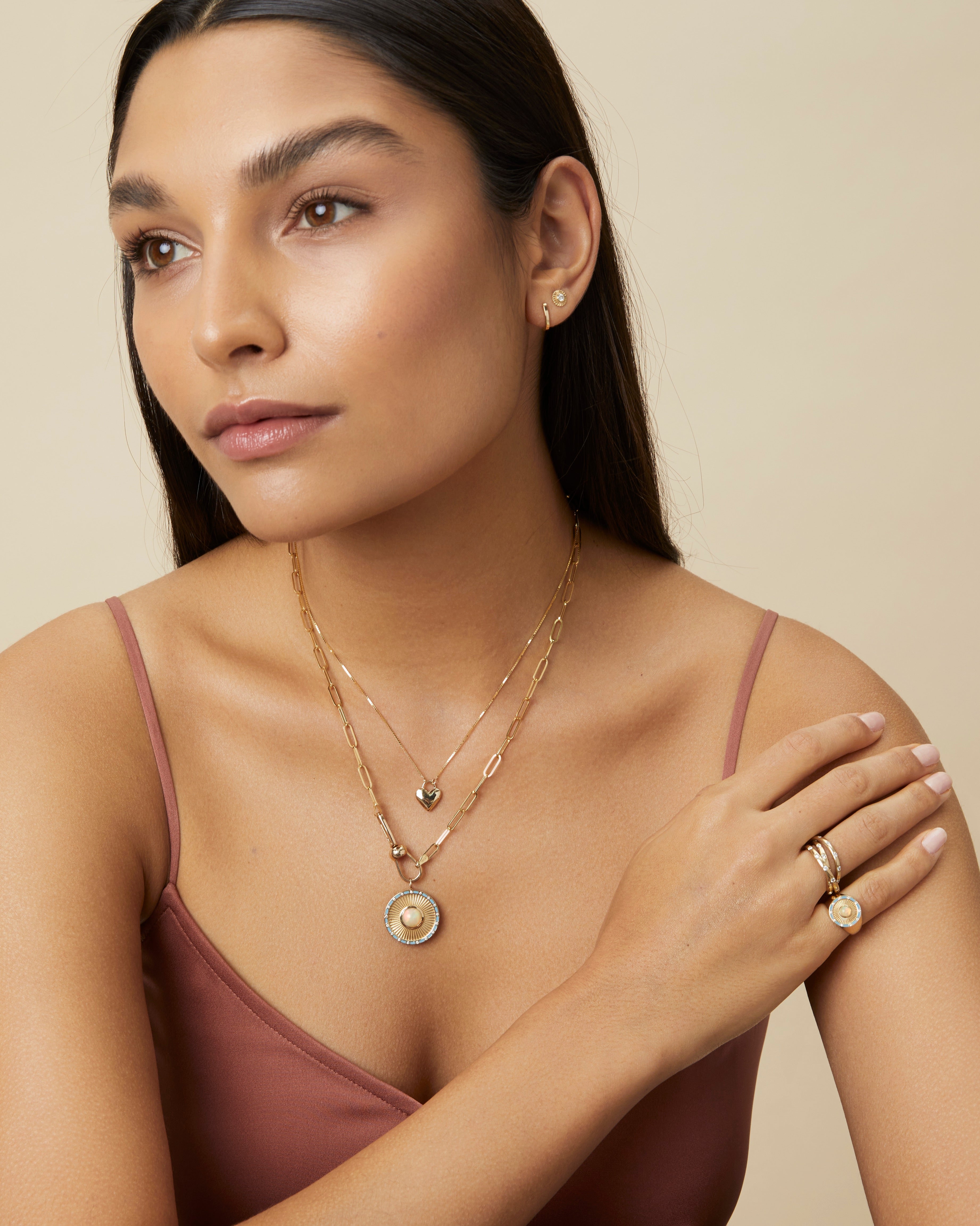 Model wearing Opal and diamond Clarity Signet Ring and Clarity Pendant symbolizing insight and optimism