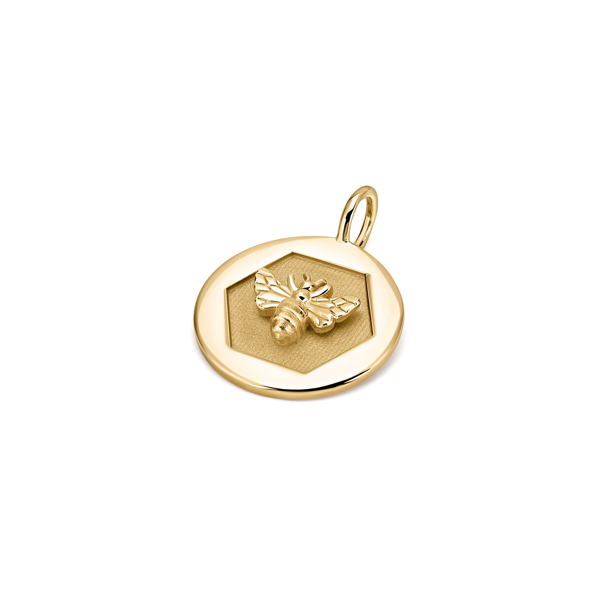 Close-up of the 14k gold Abundance Pendant with raised bee design inside a hexagon frame.